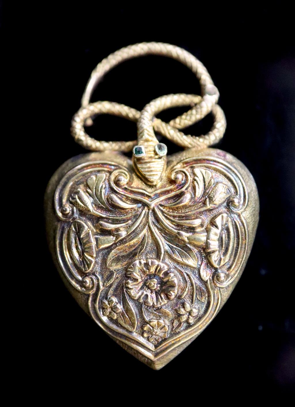 A Victorian gold and gem set heart shaped mourning pendant, with hinged serpent finial,